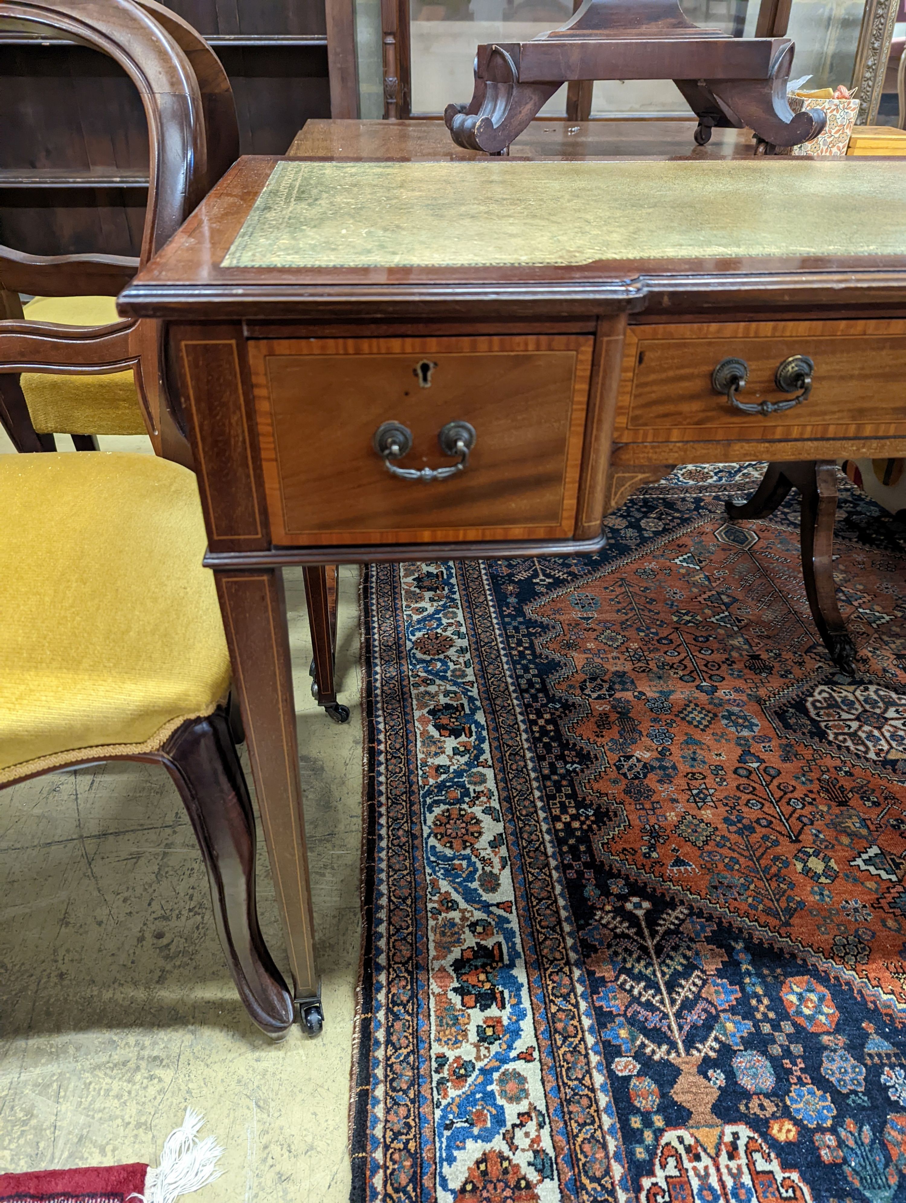 An Edwardian satinwood banded mahogany three drawer writing table, width 99cm, depth 53cm, height 75cm